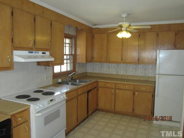 1427 Dirgie Mine Road Roxboro, NC 27574 - Photo 7 of 13 a kitchen with a sink a stove and cabinets