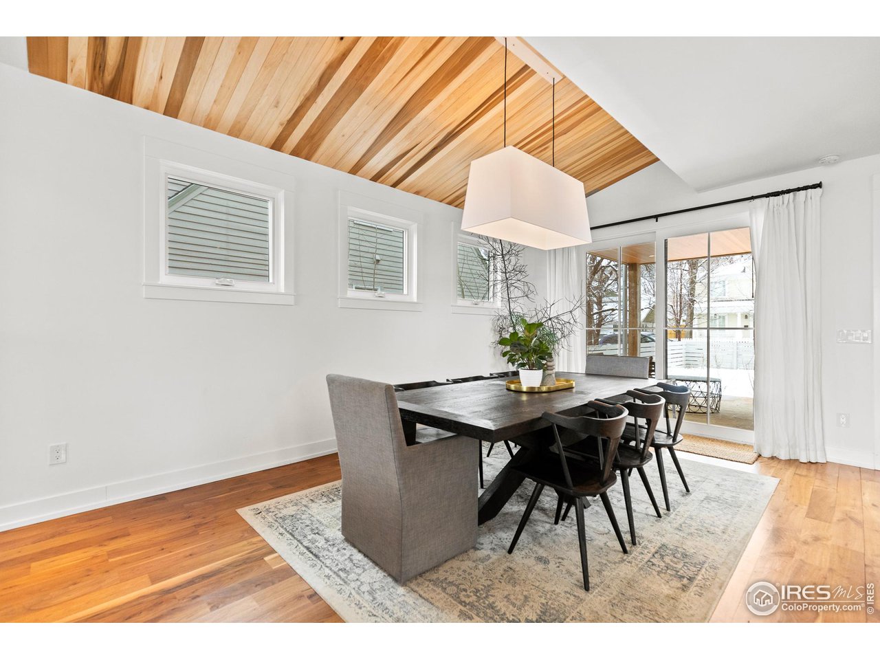 3184 9th Street Boulder, CO 80304 - Photo 12 of 39 a dining room with furniture and wooden floor