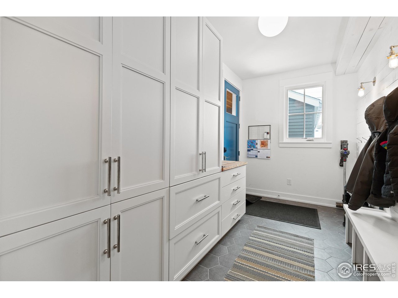 3184 9th Street Boulder, CO 80304 - Photo 16 of 39 a kitchen with white cabinets and wooden floor
