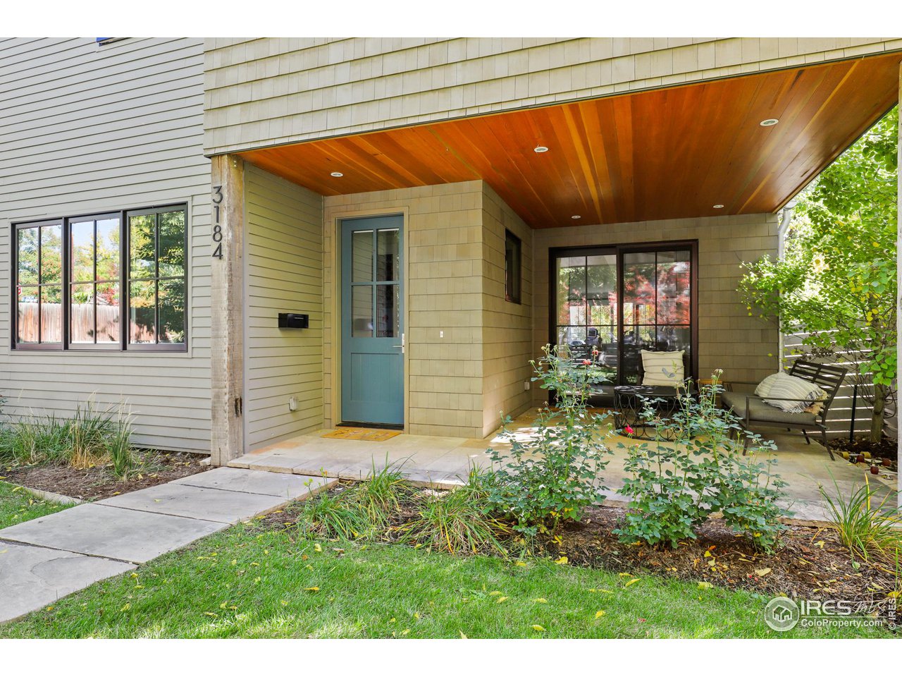 3184 9th Street Boulder, CO 80304 - Photo 2 of 39 a backyard of a house with yard and outdoor seating
