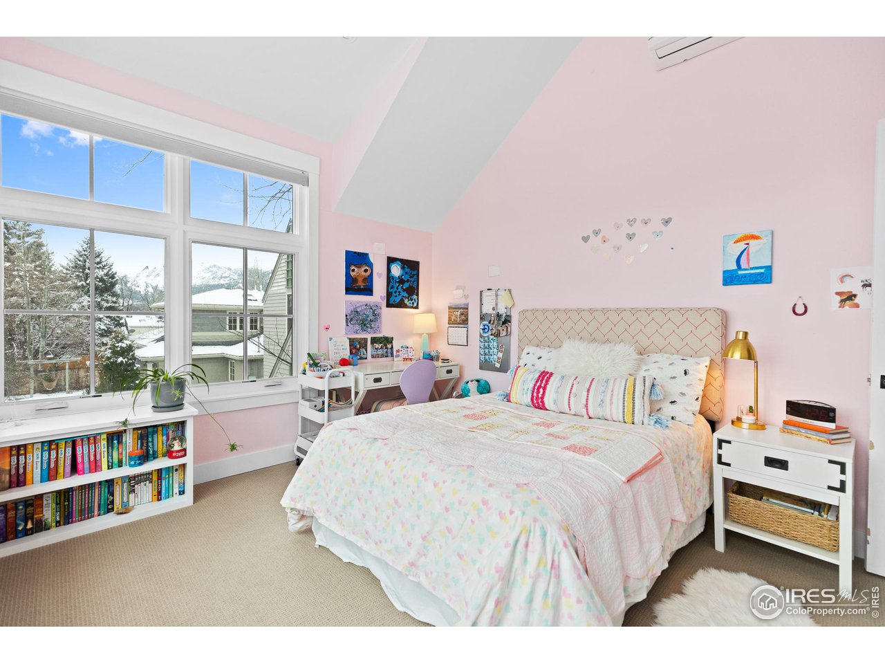 3184 9th Street Boulder, CO 80304 - Photo 29 of 39 a bedroom with a bed a large window and book shelf