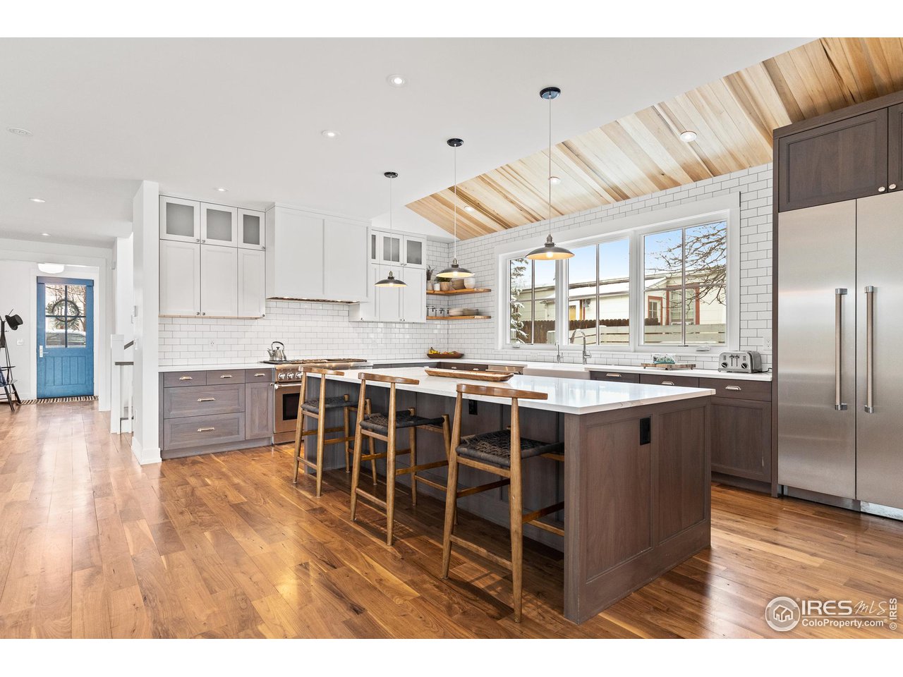 3184 9th Street Boulder, CO 80304 - Photo 4 of 39 a kitchen with kitchen island a counter top space a sink stainless steel appliances and cabinets