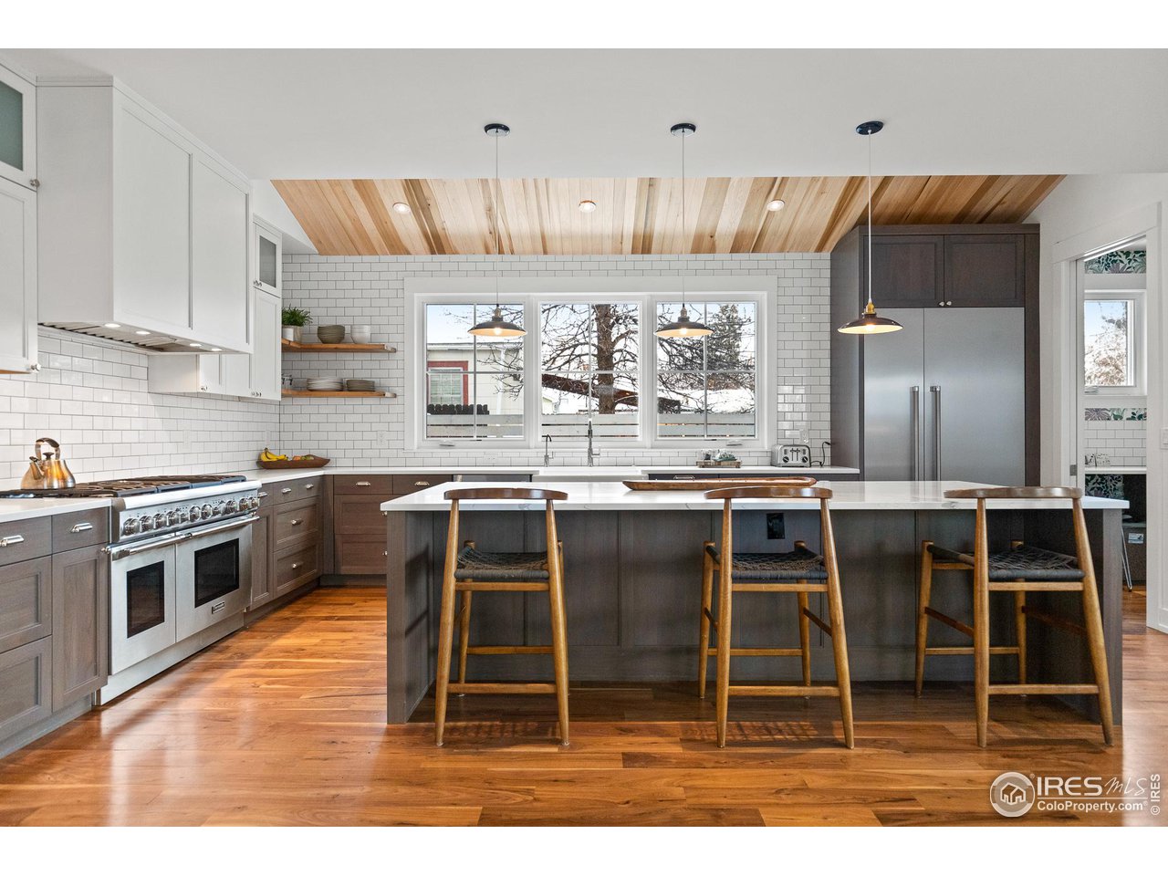 3184 9th Street Boulder, CO 80304 - Photo 5 of 39 a kitchen with kitchen island granite countertop a sink counter top space and appliances