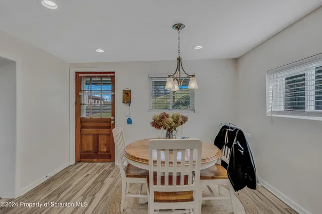 a view of a workspace with furniture and wooden floor