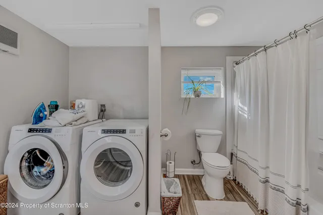 a view of bathroom with a washer and dryer
