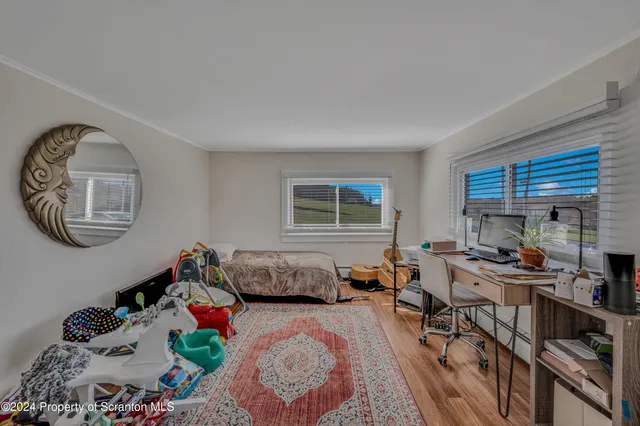 a living room with furniture a clock and a couch
