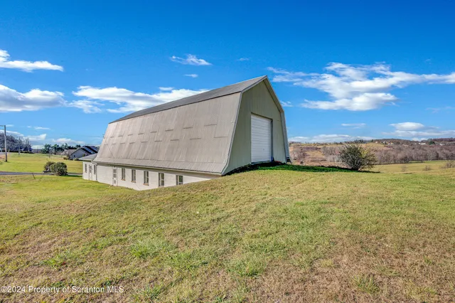 a view of a house with a yard and garage