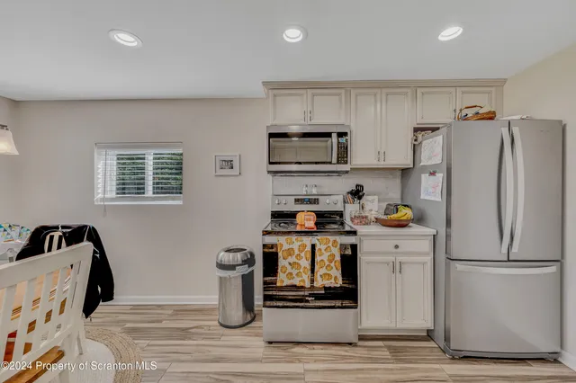 a kitchen with a refrigerator and a sink