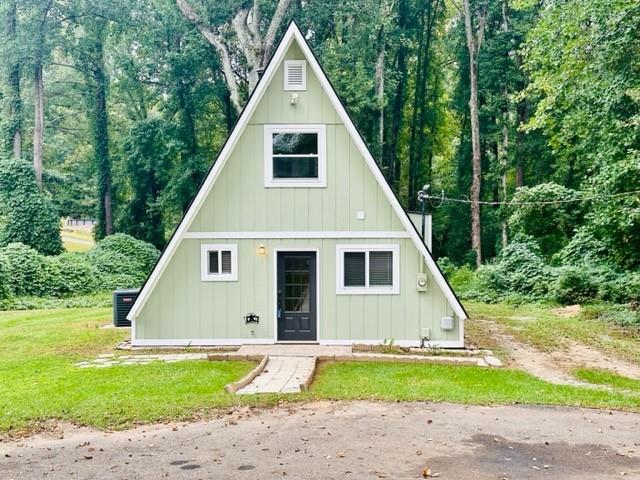 2125 Antioch Road Cumming, GA 30040 - Photo 1 of 1 a view of a yard in front of a house with large trees
