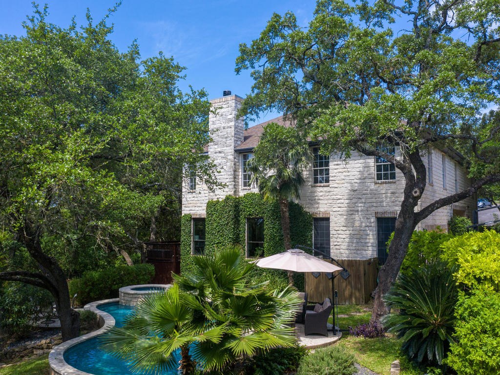 4500 Dusik Lane Austin, TX 78746 - Photo 1 of 1 a table and chairs under an umbrella