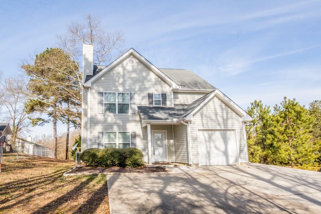851 State Street Commerce, GA 30529 - Photo 1 of 1 a front view of a house with a yard and garage