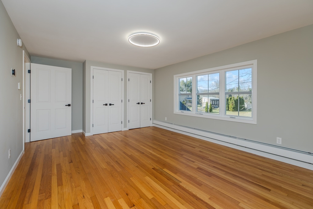 265 Stanley Street Amherst, MA 01002 - Photo 15 of 35 a view of an empty room with wooden floor and a window