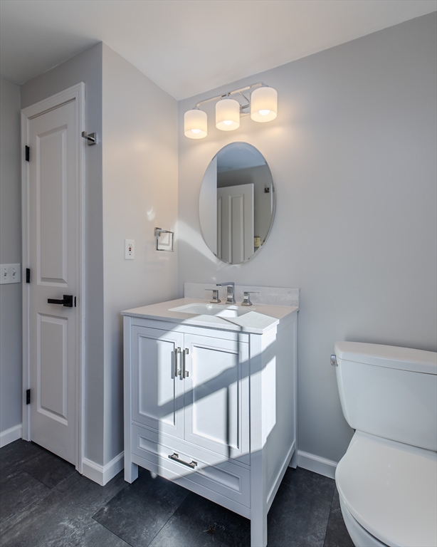 265 Stanley Street Amherst, MA 01002 - Photo 19 of 35 a bathroom with a toilet a sink and mirror