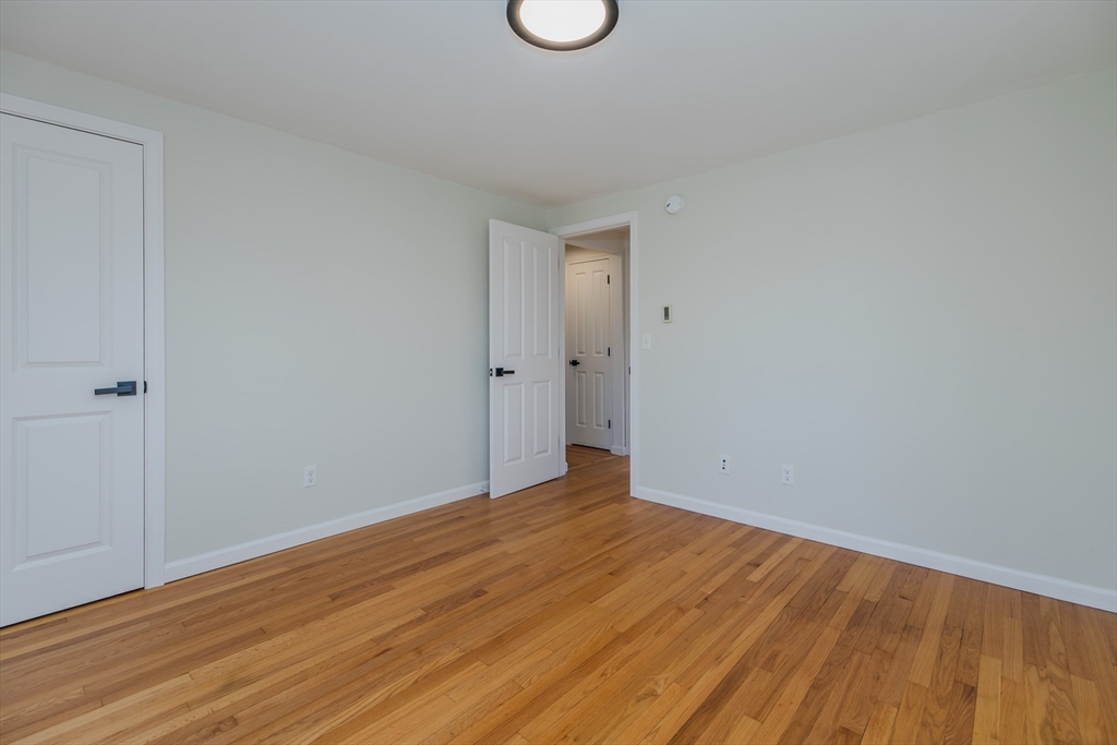 265 Stanley Street Amherst, MA 01002 - Photo 22 of 35 a view of an empty room with wooden floor and a window