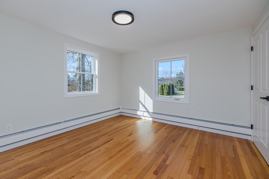 265 Stanley Street Amherst, MA 01002 - Photo 23 of 35 a view of an empty room with wooden floor and a window