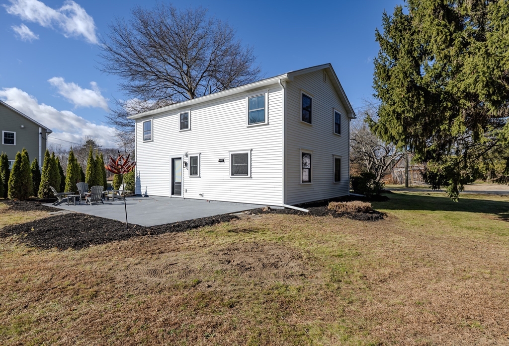 265 Stanley Street Amherst, MA 01002 - Photo 29 of 35 a view of a house with a yard covered with snow and plants