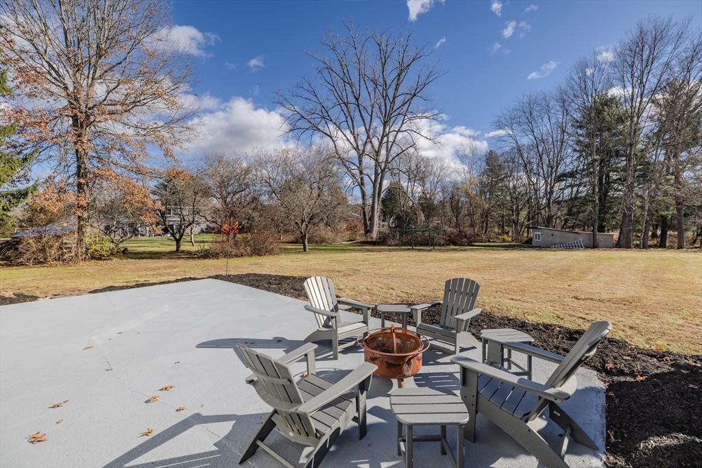 265 Stanley Street Amherst, MA 01002 - Photo 32 of 35 a view of a lake with table and chairs