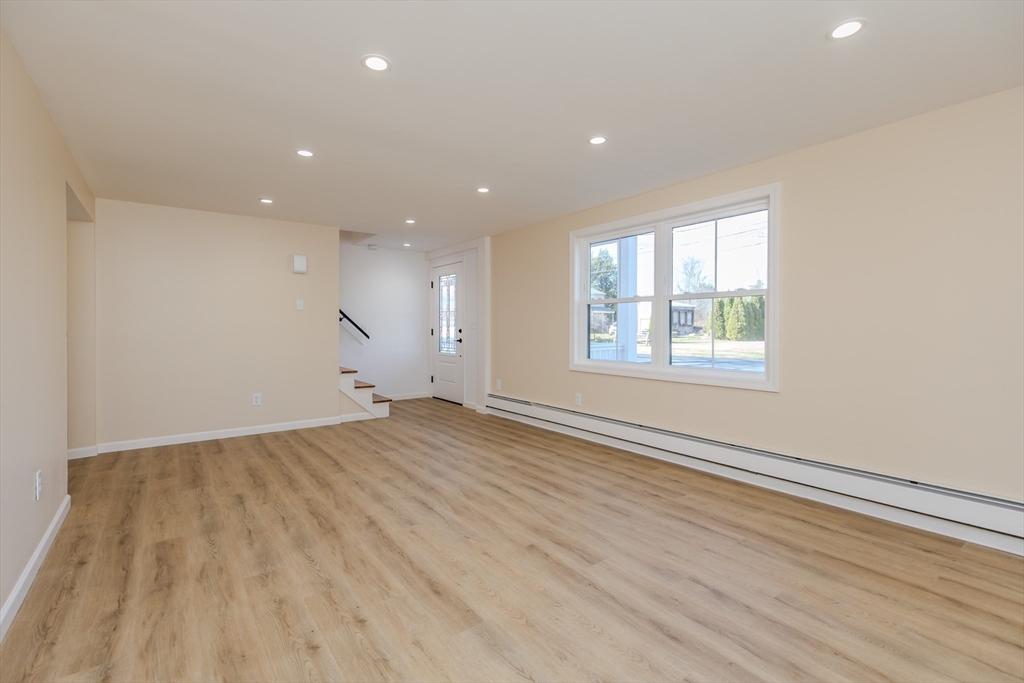 265 Stanley Street Amherst, MA 01002 - Photo 4 of 35 an empty room with wooden floor and windows