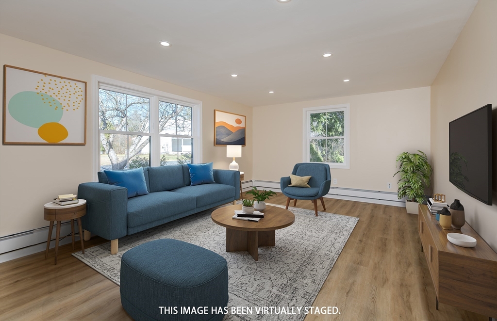 265 Stanley Street Amherst, MA 01002 - Photo 5 of 35 a living room with furniture a window and a flat screen tv