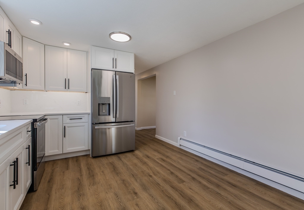 265 Stanley Street Amherst, MA 01002 - Photo 10 of 35 an empty room with wooden floor and appliances