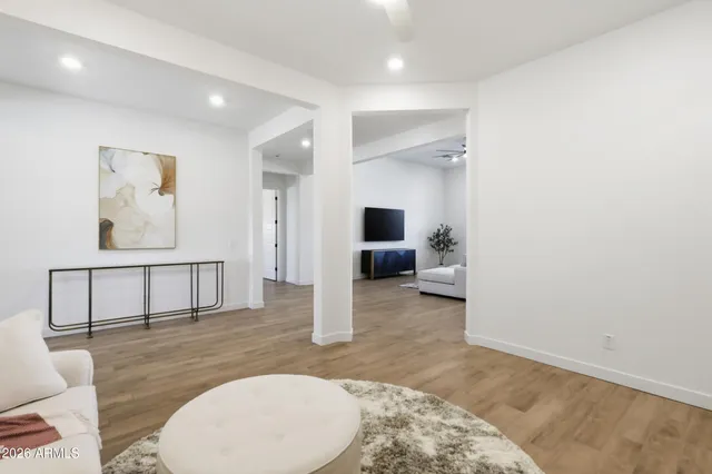 a large white kitchen with stainless steel appliances kitchen island granite countertop a sink and cabinets