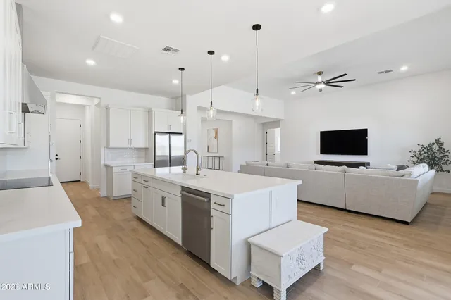 a bathroom with a double vanity sink a mirror and a bathtub