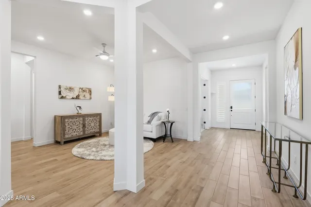 a living room with furniture and a view of kitchen