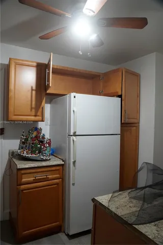 a room with refrigerator and cabinets