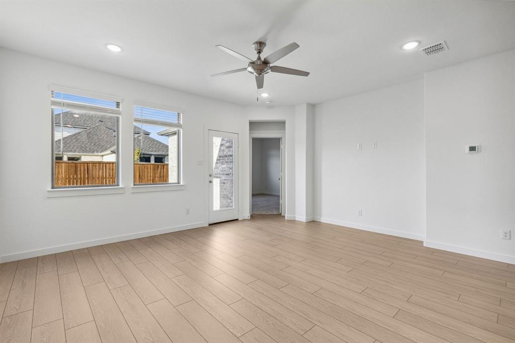 1871 Balfour Bend Forney, TX 75126 - Photo 11 of 30 a view of an empty room with a window and wooden floor