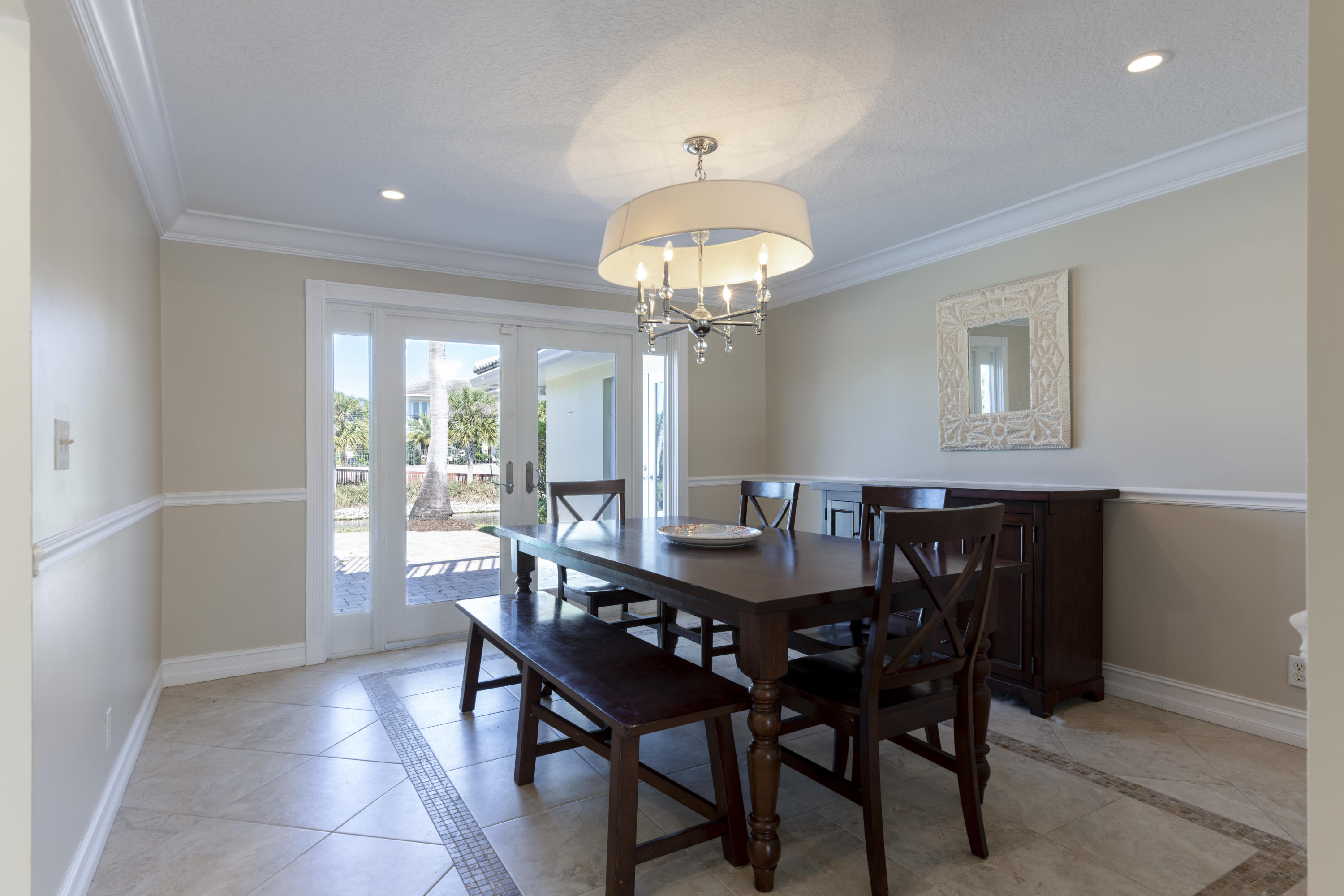 12920 Barrow Road North Palm Beach, FL 33408 - Photo 13 of 32 a view of a dining room with furniture and chandelier