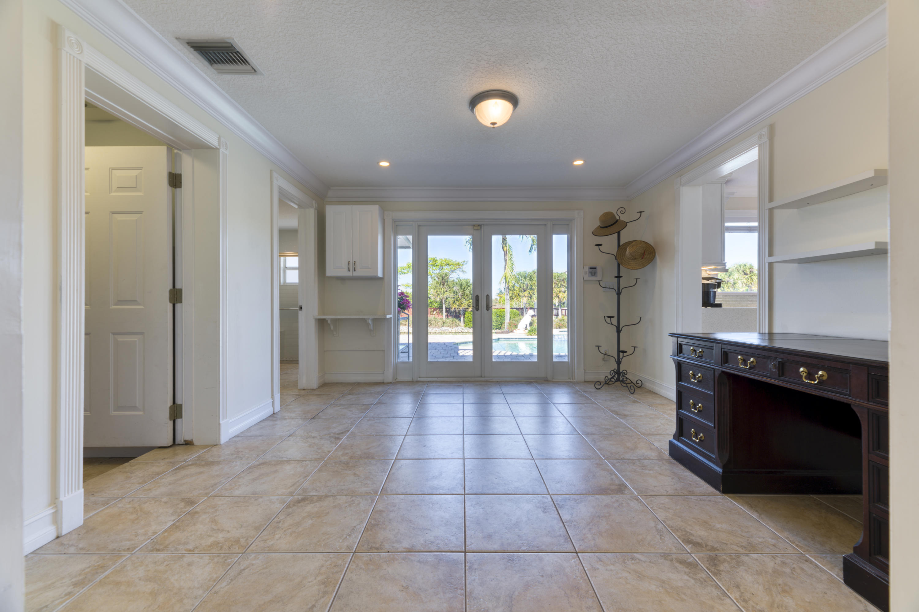 12920 Barrow Road North Palm Beach, FL 33408 - Photo 16 of 32 a view of an empty room and a kitchen