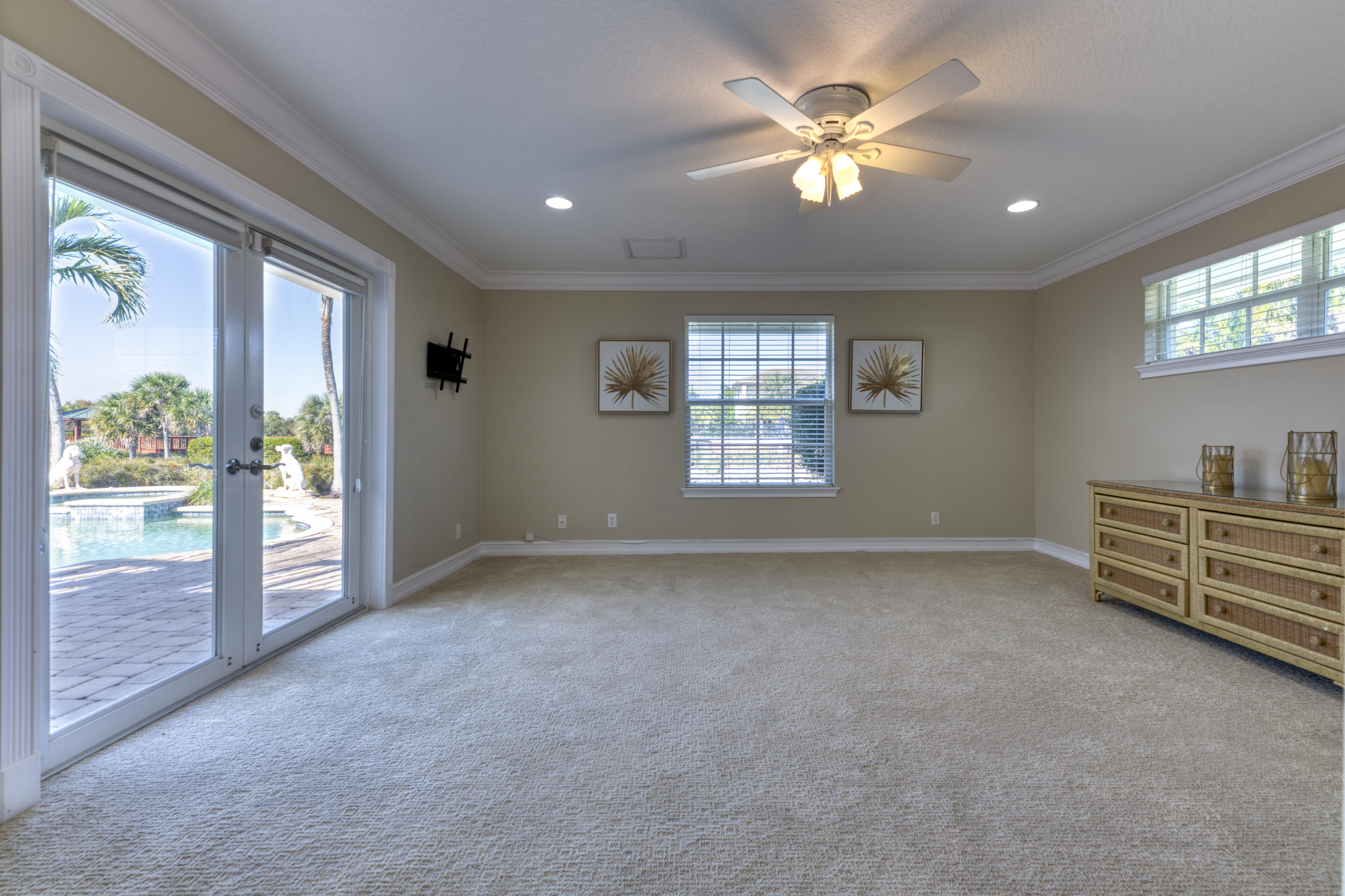 12920 Barrow Road North Palm Beach, FL 33408 - Photo 18 of 32 an empty room with windows and ceiling fan