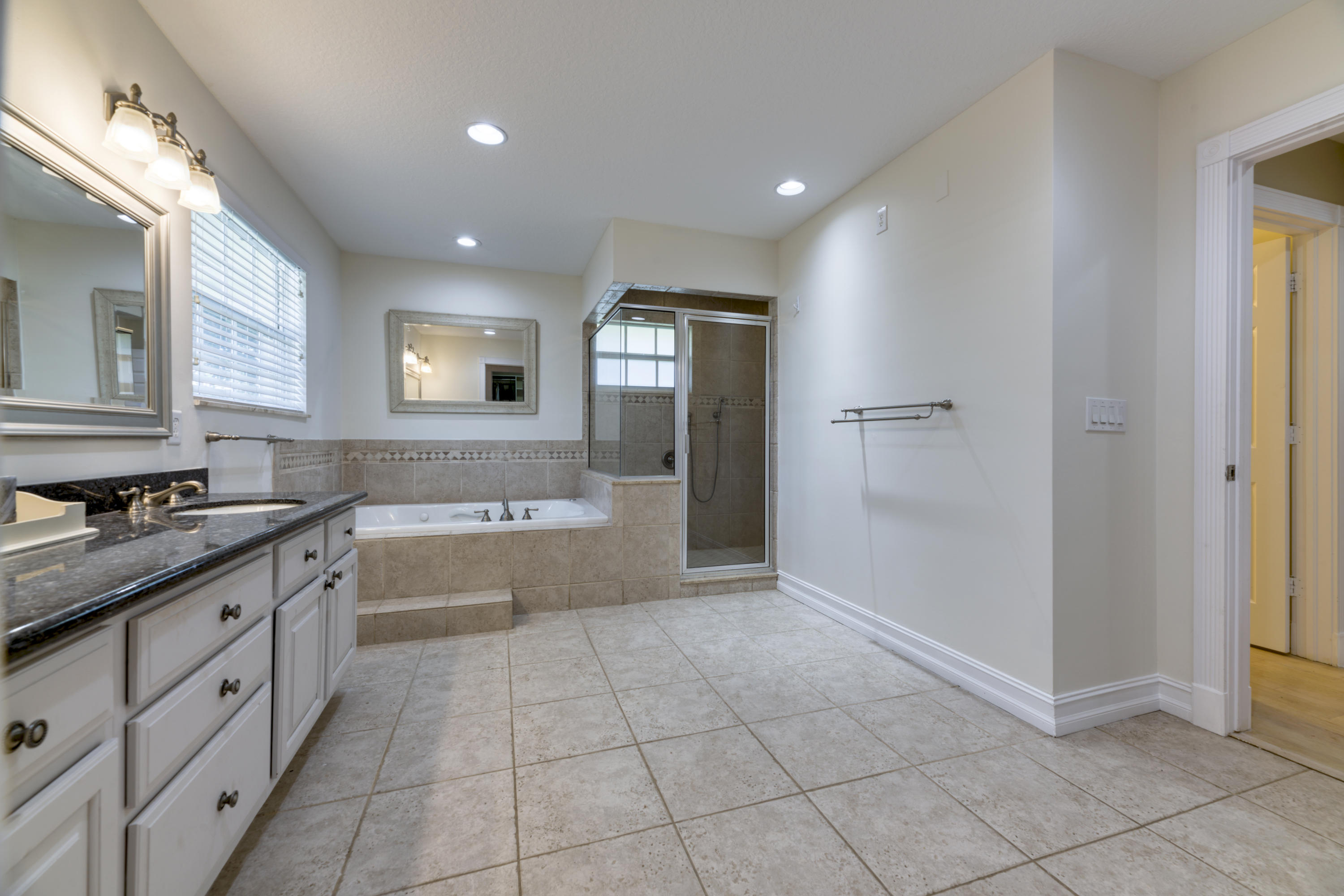 12920 Barrow Road North Palm Beach, FL 33408 - Photo 22 of 32 a bathroom with a sink a vanity and a mirror