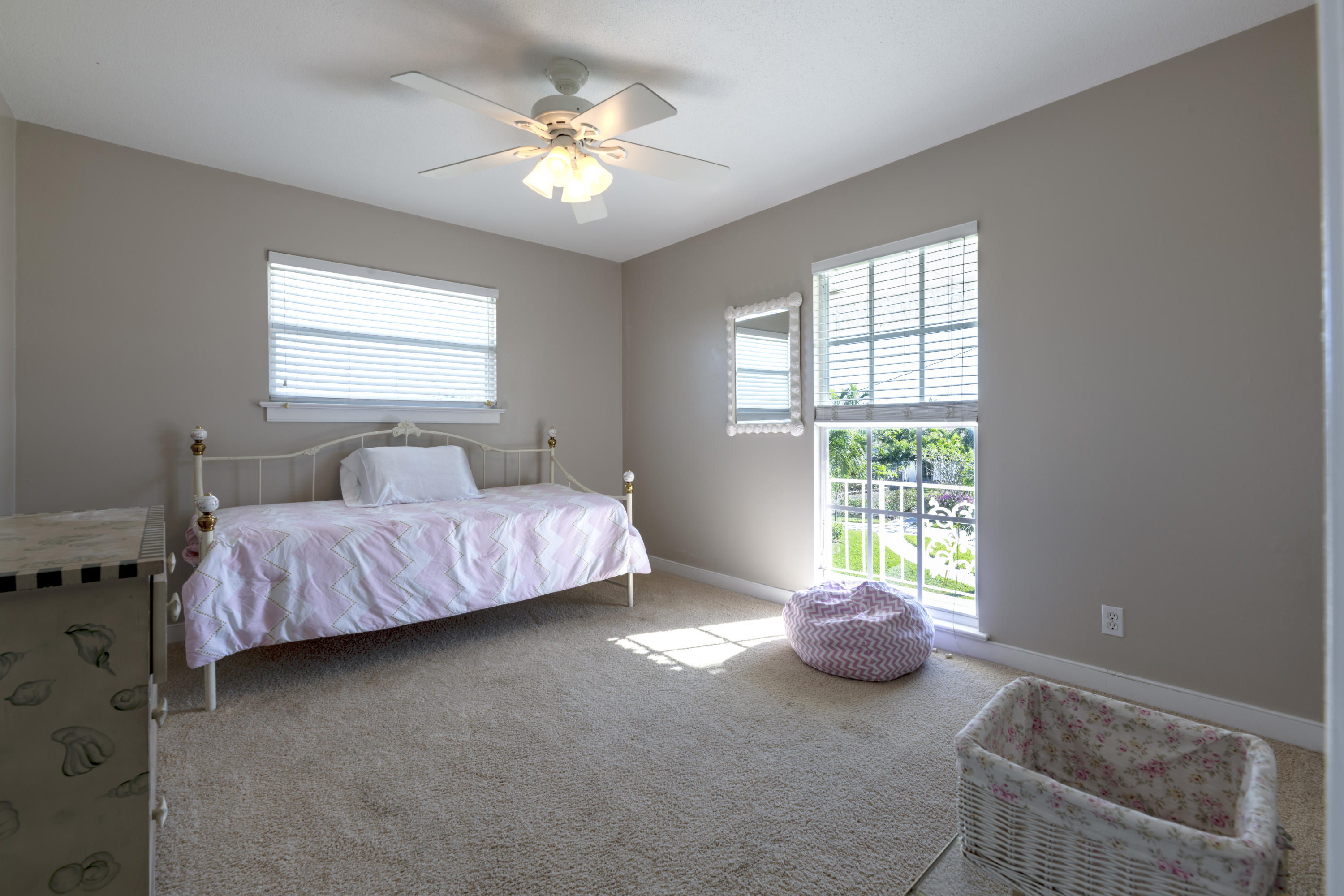 12920 Barrow Road North Palm Beach, FL 33408 - Photo 23 of 32 a bedroom with a bed and a chandelier