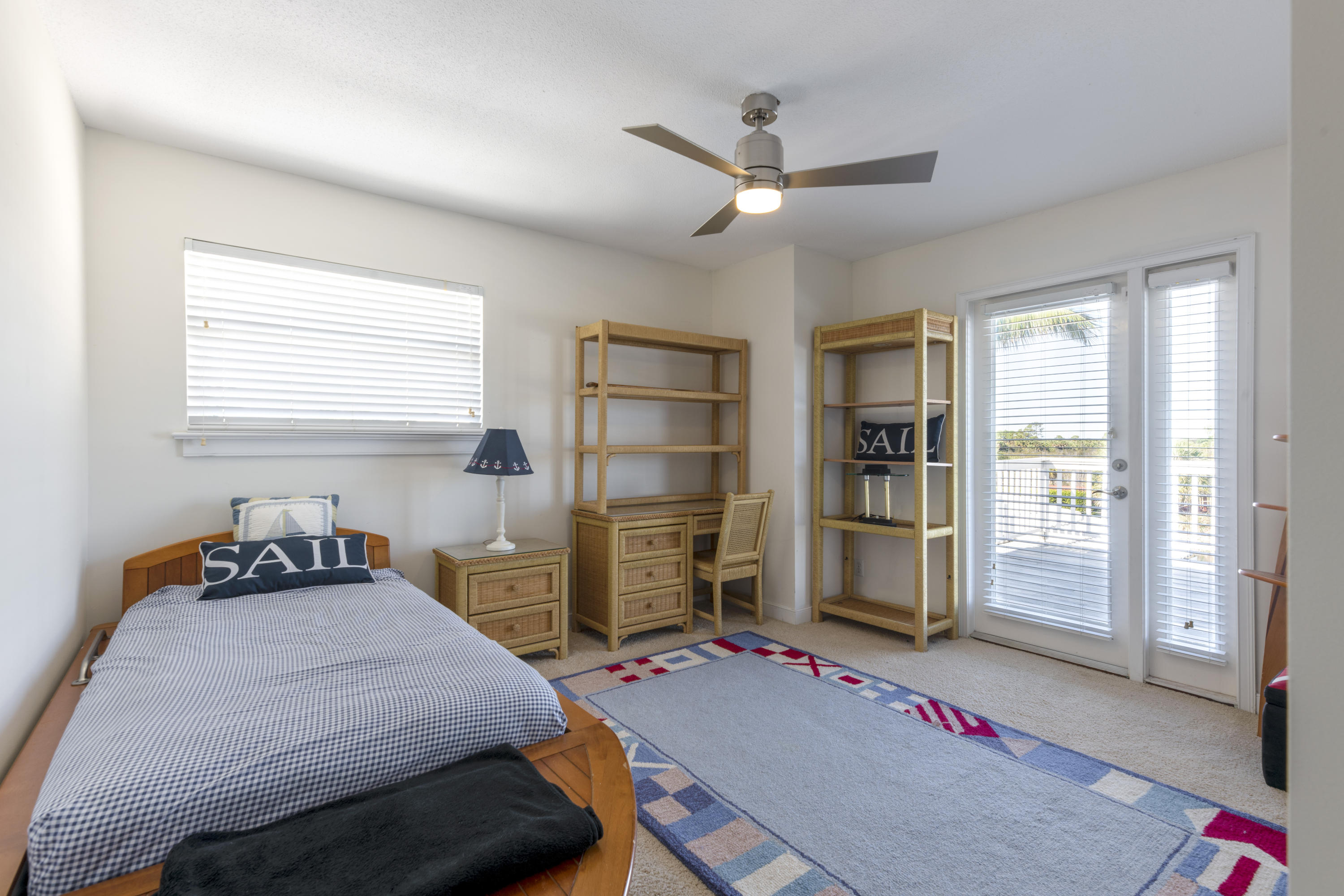 12920 Barrow Road North Palm Beach, FL 33408 - Photo 26 of 32 a bedroom with a bed and wooden floor