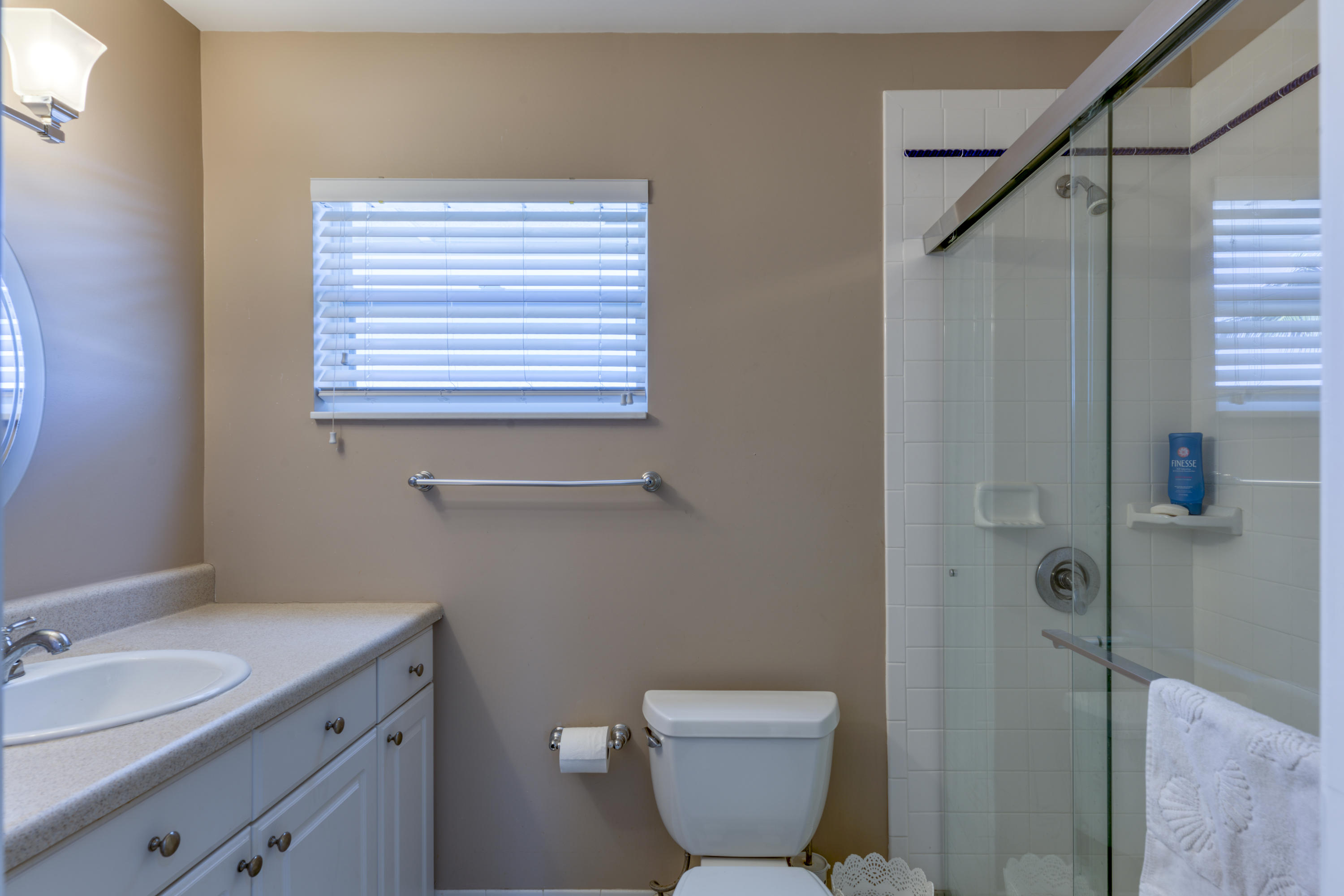12920 Barrow Road North Palm Beach, FL 33408 - Photo 27 of 32 a bathroom with a granite countertop sink toilet and shower