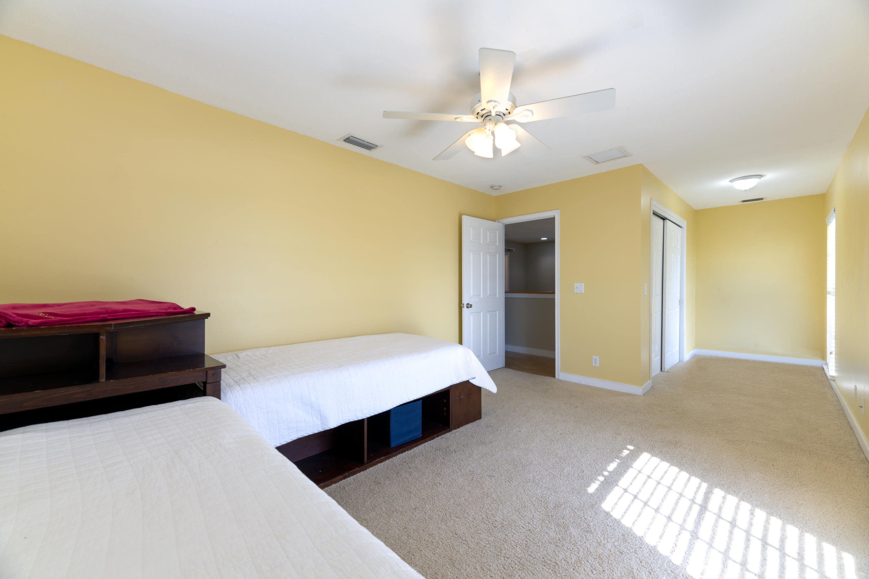 12920 Barrow Road North Palm Beach, FL 33408 - Photo 28 of 32 a bedroom with a bed and a chandelier