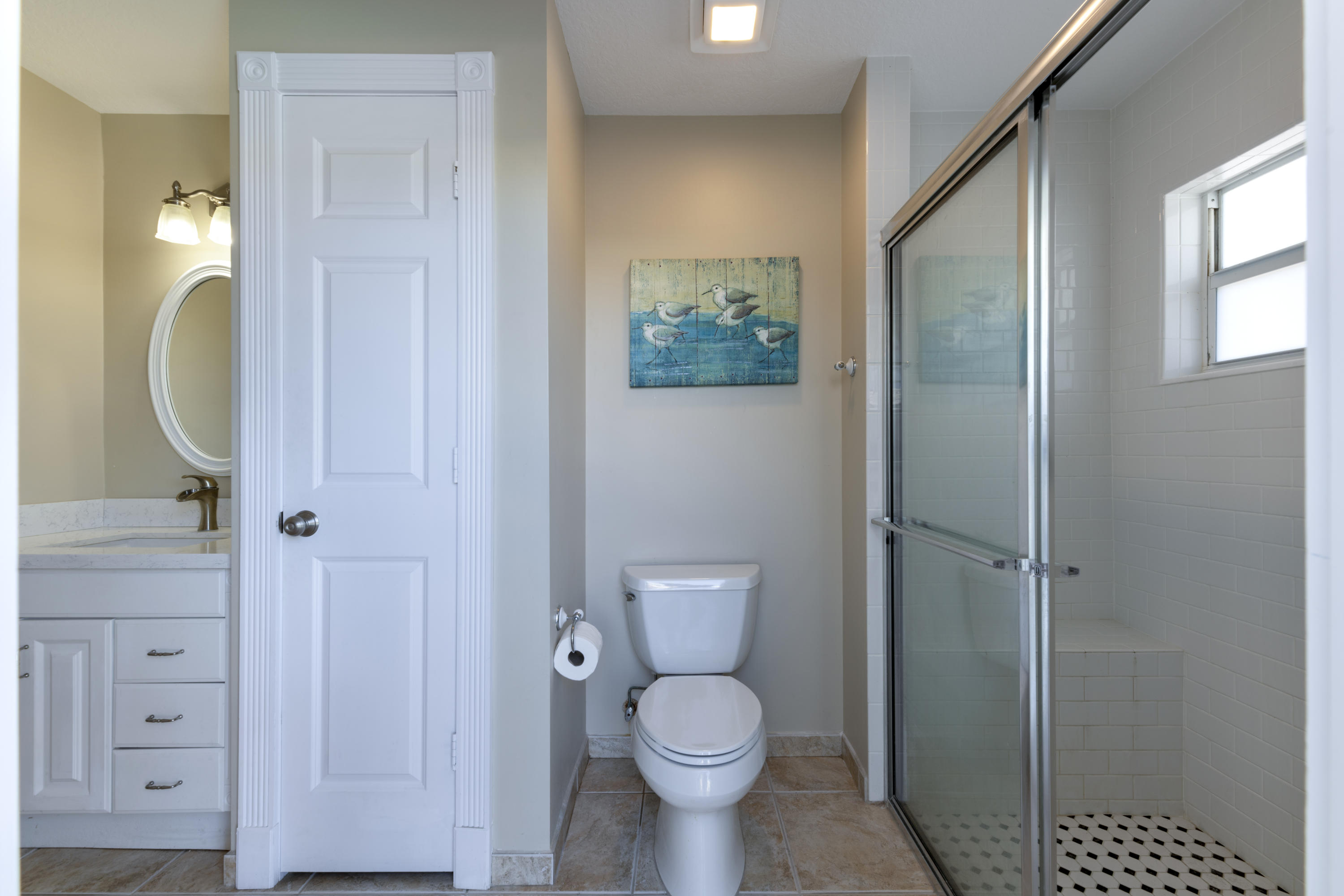 12920 Barrow Road North Palm Beach, FL 33408 - Photo 30 of 32 a bathroom with a toilet a sink and shower
