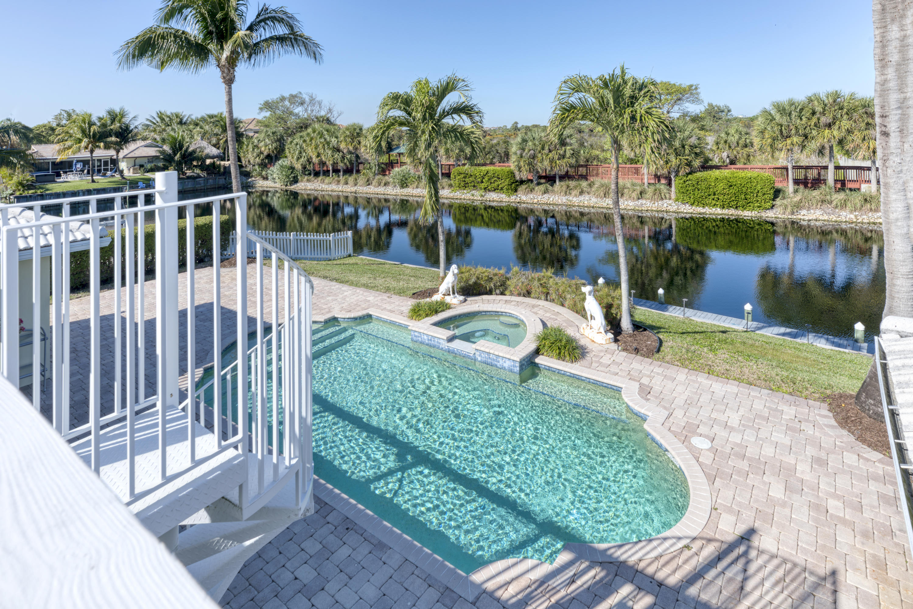 12920 Barrow Road North Palm Beach, FL 33408 - Photo 5 of 32 a view of a swimming pool with a patio and a yard