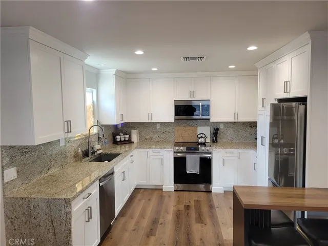a kitchen with a sink stove and refrigerator