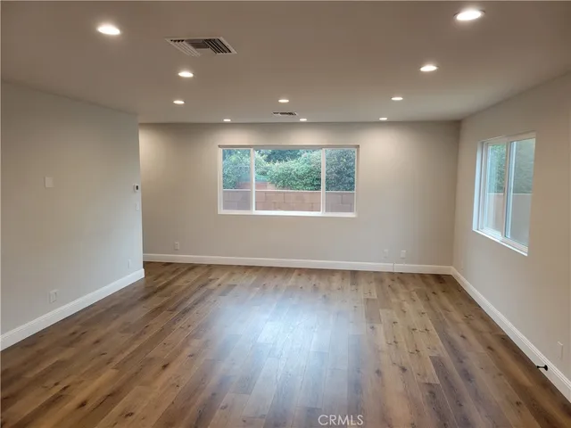 a kitchen with stainless steel appliances granite countertop a stove top oven a sink and a refrigerator