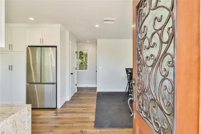 a kitchen with granite countertop white cabinets and white appliances