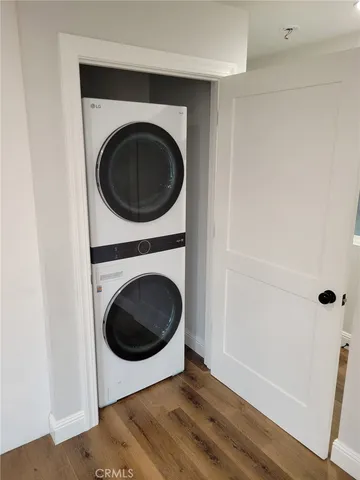 an empty room with wooden floor and window