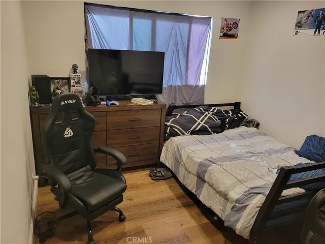 a bedroom with a bed and flat screen tv