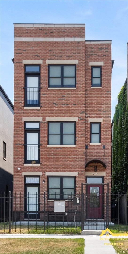 a front view of a building with a yard