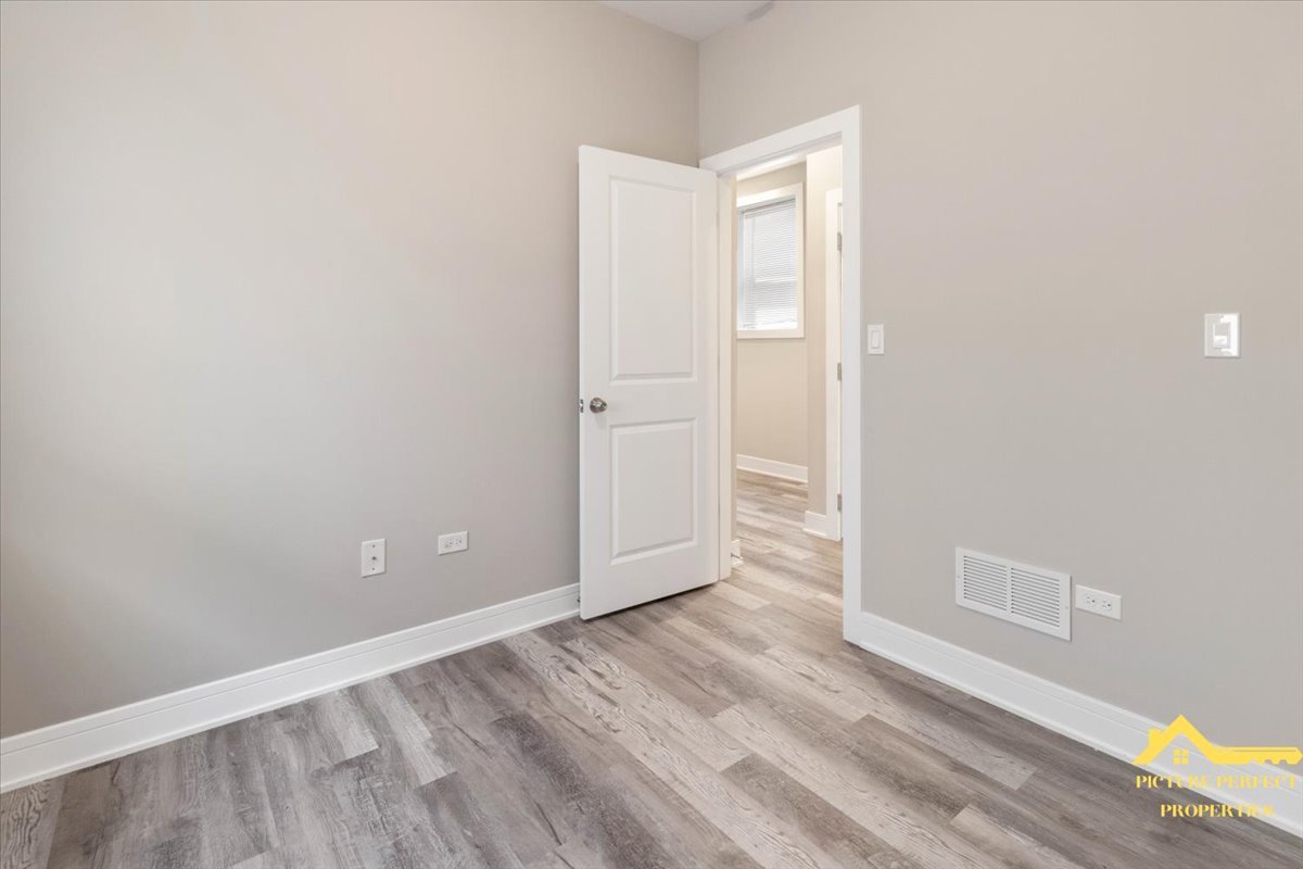 6337 South Ellis Avenue, Unit 3 Chicago, IL 60637 - Photo 4 of 12 a view of an empty room with wooden floor