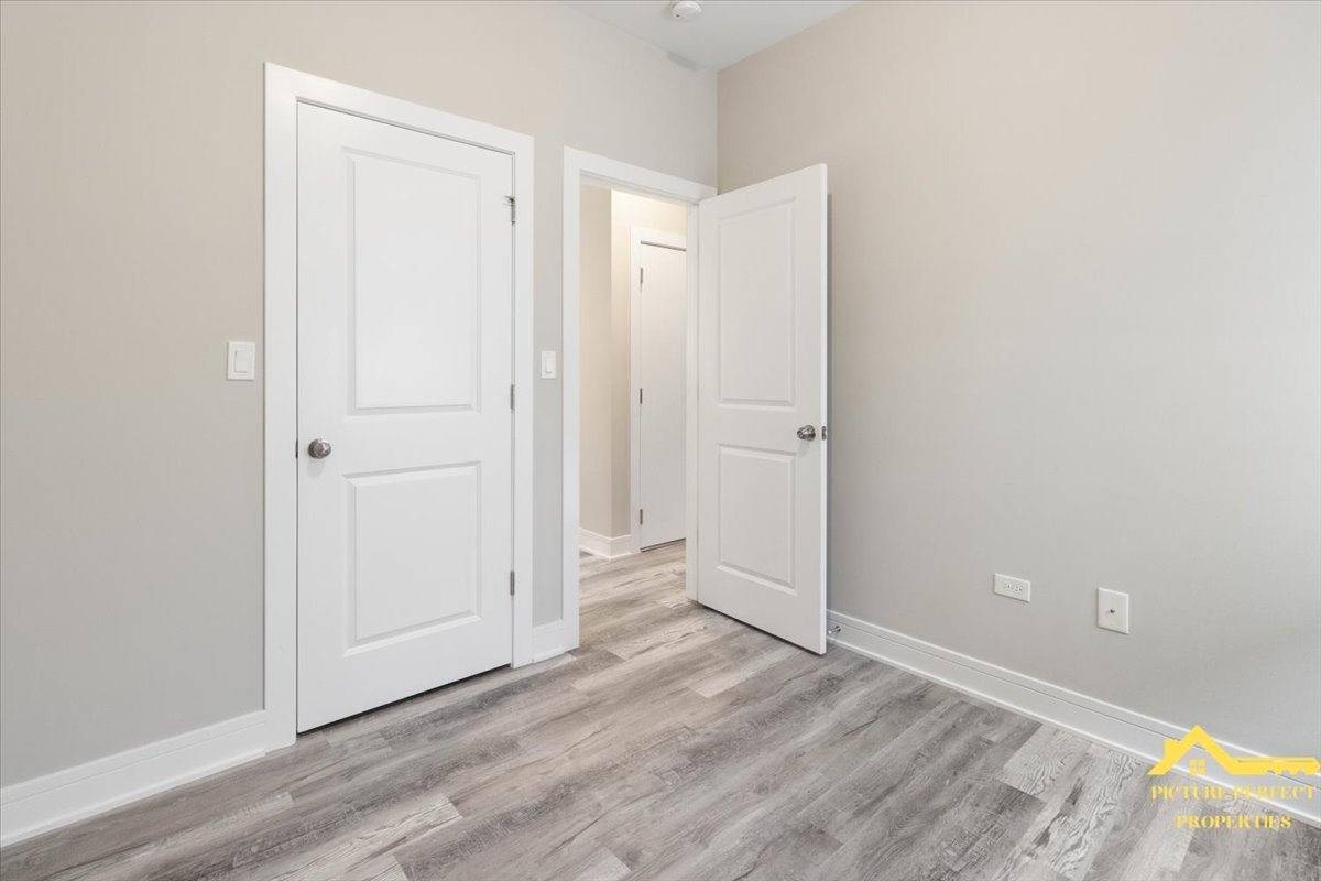 6337 South Ellis Avenue, Unit 3 Chicago, IL 60637 - Photo 5 of 12 an empty room with wooden floor