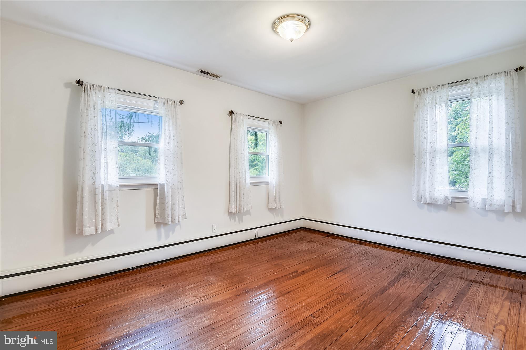 1137 Hampton Road Annapolis, MD 21409 - Photo 6 of 61 Primary Bedroom has 3 Windows & Wood Floors