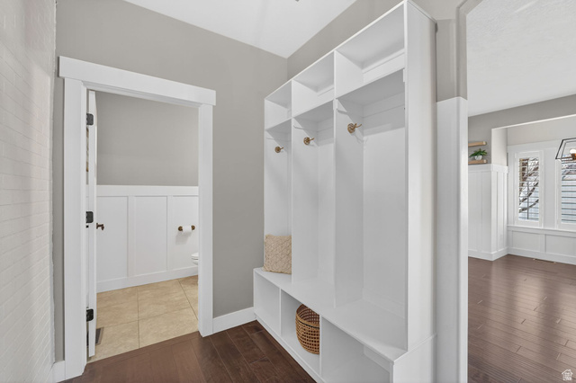 14714 South Bright Wood Road Herriman, UT 84096 - Photo 17 of 41 Mudroom featuring a wainscoted wall, dark wood-type flooring, and a decorative wall