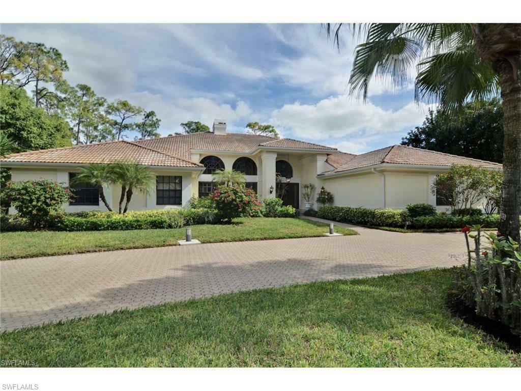a front view of a house with a garden and yard